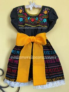 "Floral embroidery mexican dress girls, black mexican blouse, serape midi skirt, mexican girls outfit, hispanic heritage, cambaya skirt, cinco de mayo, fiesta san antonio, charro days, sombrero fest, mexidan dress, serape skirt, mexicanblouse This adorable mexican dress - 3 pieces clothing set: Floral embroidered top, serape skirt and sash Skirt is black with a colorful design that reads \"Mexico\" all over Hand-embroidered black top Fit size 4-5 years old Measurements taken flat: Top Armpit to Black Dresses For Cinco De Mayo Fiesta, Traditional Black Dress For Cinco De Mayo, Mexican Girl Outfit, Charro Days, Colombian Wedding, Embroidery Mexican, Mexican Blouse, Mexican Dress, Floral Embroidered Top