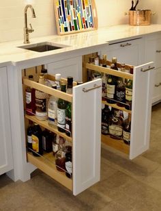 an open cabinet in the middle of a kitchen