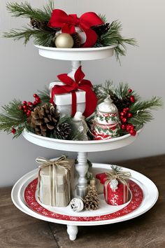 three tiered trays with christmas decorations on them