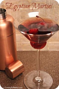 an egyptian martini is garnished with raspberries