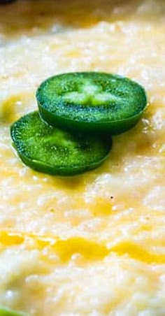 cucumber slices are placed on top of a bowl of oatmeal