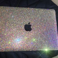 an apple laptop covered in lots of glitter