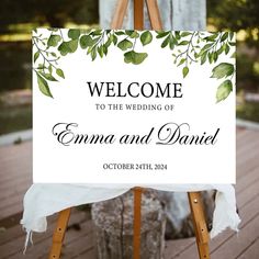 an easel with a sign that says welcome to the wedding of emma and daniel