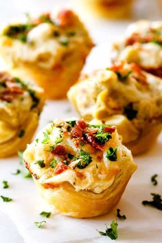 several small muffins with bacon and cheese on them