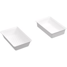 two white dishes sitting next to each other on a white surface with no one in it