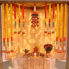 a table with food and decorations on it in front of a window covered in lights