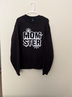 This is a MOMster Crewneck or T-shirt you can order. This is a great big design for spooky season. The design can be glitter White which is what the picture shows or I can do regular white as well. If you have any questions or interested in a different color combo please let me know, feel free to send me a message. Spooky Black T-shirt For Winter, Black Custom Print Tops For Winter, Black Custom Print Top For Winter, Winter Black Top With Custom Print, Halloween Band Merch Sweatshirt With Graphic Print, Halloween Cotton Sweatshirt With Graphic Print, Halloween Graphic Print Cotton Sweatshirt, Black Horror Graphic Sweatshirt, Black Horror Graphic Print Sweatshirt