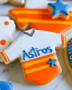 decorated cookies with the name astros on them are arranged in different shapes and sizes