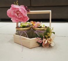 two jars filled with flowers sitting on top of a table