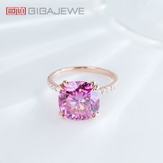 a pink diamond ring with diamonds around it