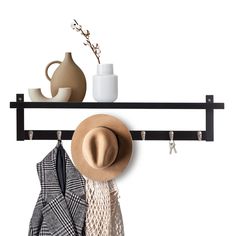 a hat, scarf and coat hanger on a rack with clothes hanging from it