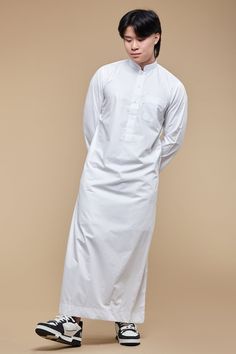 A classic white Jubba with a high collar. This Jubba can be worn for both casual and smart wear. A tailored look with a sophisticated finish.  HEIGHT OF MODEL: 165 cm. / 5' 9" Size 58/Large Colour: White Style: Casual & Occasion Composition: 100% Polyester Care: Machine Washable White Long Sleeve Thobe For Formal Occasions, Formal White Long Sleeve Thobe, Casual White Long Sleeve Thobe, White Stand Collar Kurta For Eid, Classic Fitted Long Sleeve Kurta, Traditional White Thobe For Formal Occasions, Traditional White Formal Thobe, White Fitted Kurta With Stand Collar, White Long Sleeve Thobe For Eid