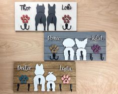 three wooden signs with dogs and their names on them