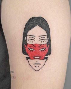 a woman's face has been drawn onto the side of her thigh and is wearing a red mask