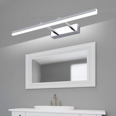 a bathroom vanity with a mirror and lights above it