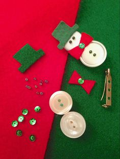 the sewing supplies are laid out on the green carpet next to the red and white christmas stocking