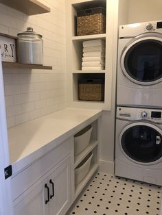 a washer and dryer in a white laundry room with black and white flooring