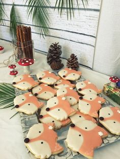 some cookies are on a table with pine cones