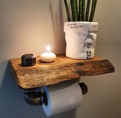 a toilet paper roll holder with a candle on it