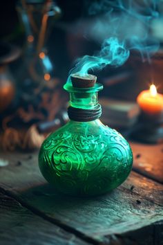 a green glass bottle sitting on top of a wooden table next to a lit candle