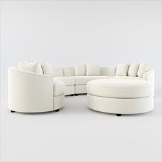 a white couch and ottoman with pillows on it