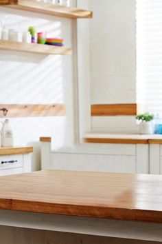 a wooden table top in a white kitchen