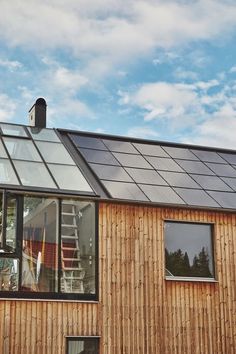 a wooden house with solar panels on the roof