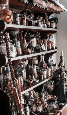 a shelf filled with lots of jars and vases