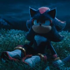 sonic the hedgehog is sitting in the grass