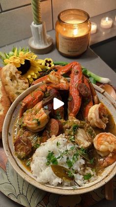 a bowl filled with shrimp, rice and vegetables