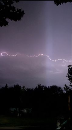 the sky is filled with lightning as it shines brightly in the dark night time