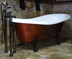 an old fashioned claw foot bathtub in a bathroom