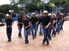 a group of men walking down a street next to each other