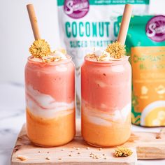 two jars filled with food sitting on top of a wooden board next to each other