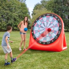 a family playing with an inflatable dart and ball game