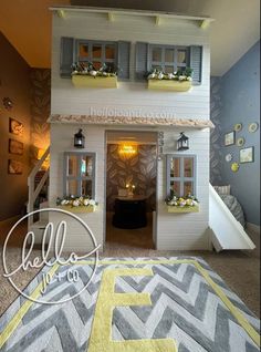 the doll house is decorated with yellow and gray accents, along with white stairs leading up to the second floor