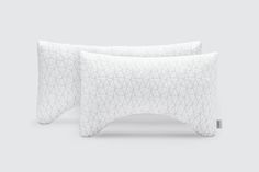 two white pillows sitting next to each other