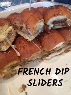 french dip sliders on a plate with toothpicks sticking out of the top