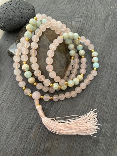 A beautiful stylish light colors Mala necklace, made with Rose Quartz beads, light blue Agate beads brass beads for a gold-ish touch and a light pink color tassel. A necklace that you can easily match any outfit, use it as a decor item, and also use for meditation. A most have addition to your necklace collection. The Mala necklace has a drop length of 45.7cm- 18 inch, the tassel at the bottom is 7.5cm- 3 inch long. ⚡️Join Akashi's VIP list for early bird discount access⚡️ Paste into your browse Rose Quartz Mala, Wiccan Necklace, Yoga Lover Gift, Natural Opal Ring, Mens Gemstone Rings, Karma Necklace, 108 Mala Beads, Brass Beads, Rose Quartz Bracelet