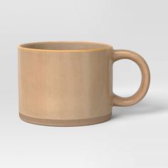 a coffee cup is shown on a white background, with the bottom half painted beige