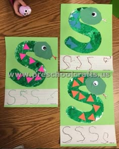 two paper plates with green and pink designs on them, one is shaped like a snake