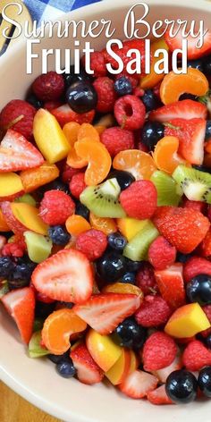 a white bowl filled with fruit salad on top of a wooden table