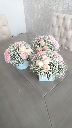 three blue vases filled with pink and white flowers