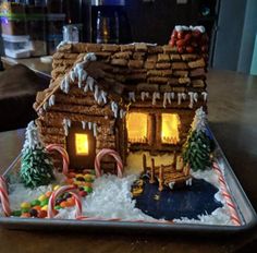 a gingerbread house decorated with candy canes and icing