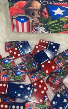 several red, white and blue dices are laying on the ground next to an american flag bag