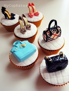 four cupcakes decorated with different types of shoes and purses