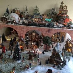 a christmas village is shown with lights and trees