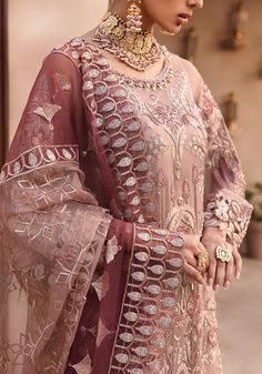 Embroidered Kameez with Wedding Lehenga and Dupatta is an elegant masterpiece that will give you a head-turning look on the big day. Sequins, motifs, beaming details, and classic contrast of peach color make this embroidered kameez a perfect choice for the wedding. The lavish details of Gota and embroidery make this beautiful lehenga Dress an epitome of beauty and your foremost priority. Embroidered Kameez: The beautiful kameez comes in a lavish tea-pink shade. The shimmering ornaments and embro Wedding Eid Dupatta With Intricate Embroidery, Traditional Unstitched Organza Suit For Wedding, Traditional Organza Unstitched Suit For Wedding, Traditional Organza Unstitched Wedding Suit, Bollywood Unstitched Suit With Intricate Embroidery For Wedding, Intricate Embroidered Churidar For Wedding And Eid, Wedding Churidar With Intricate Embroidery For Eid, Organza Churidar With Intricate Embroidery For Reception, Intricate Embroidery Churidar For Wedding