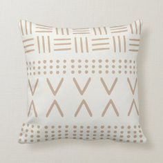 a beige and white pillow with brown lines on the front, and dots on the back