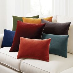 a couch with many different colored pillows on it